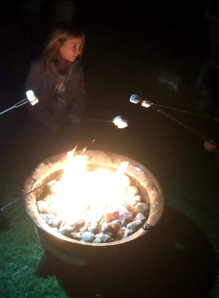My daughter with a bunch of marshmallows at a
campfire.